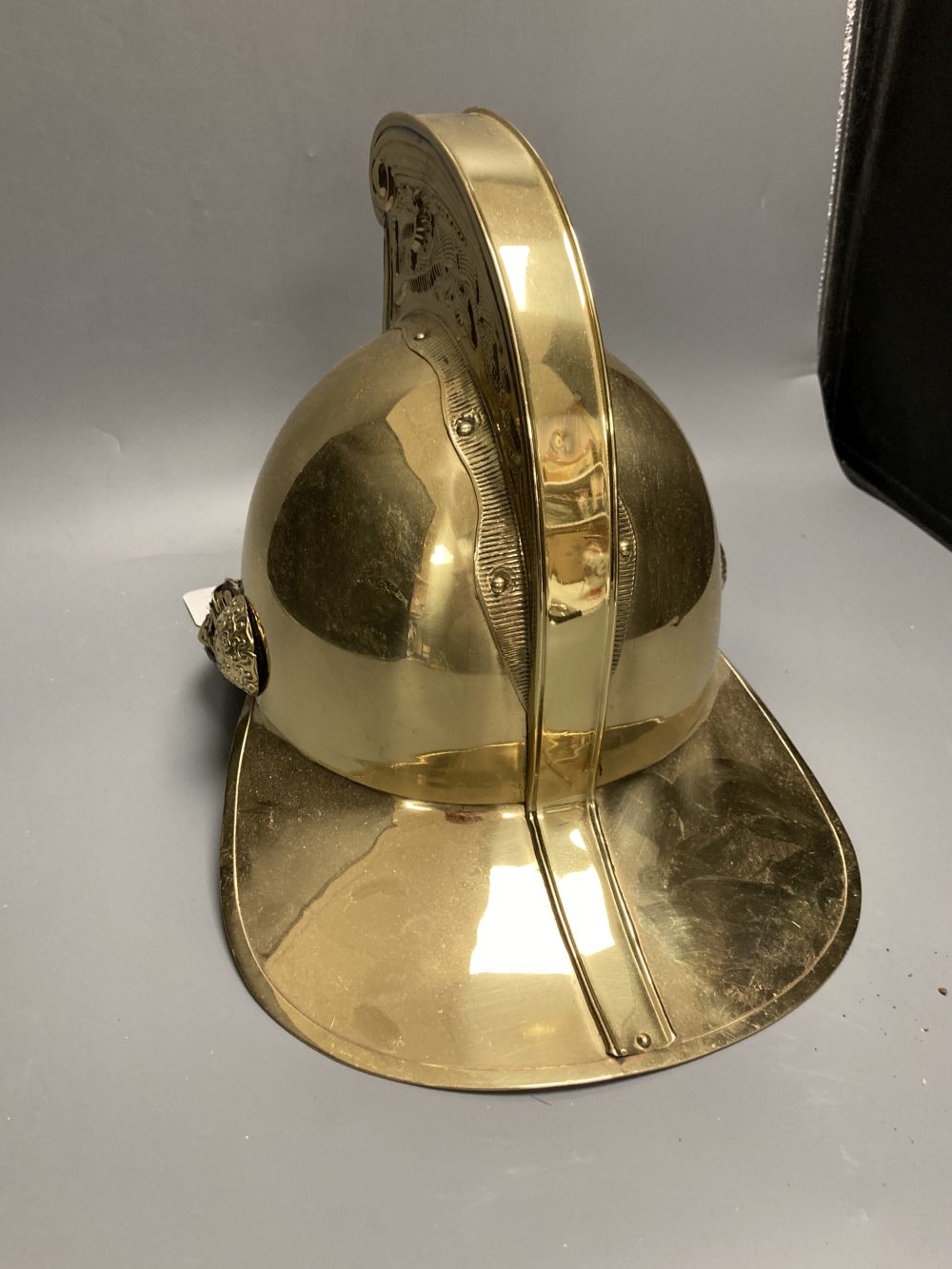 A reproduction brass firemans helmet, height 27cm